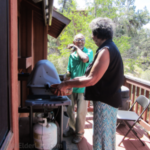 Couple BBQ on porch, knowing they have good Medi-Cal planning to protect their home